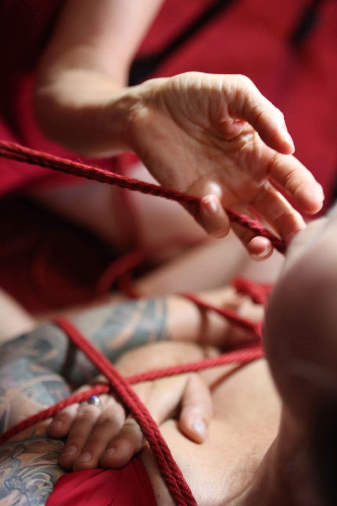 Detail of red rope against skin